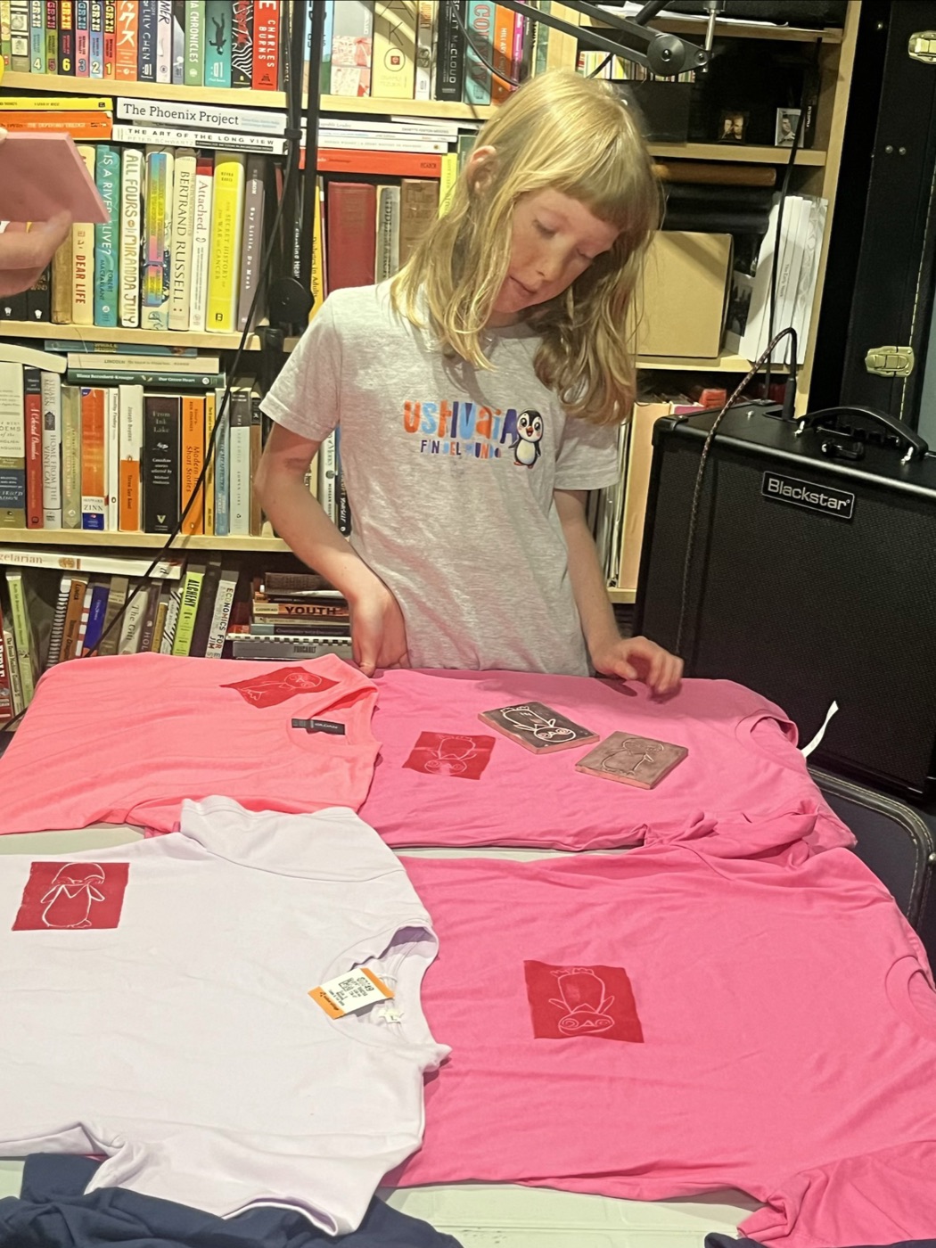 Beatrix laying out shirts and linocut blocks