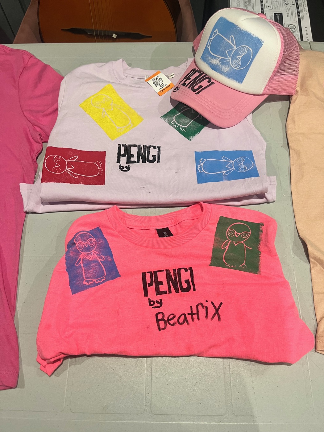 Beatrix signing a batch of shirts
